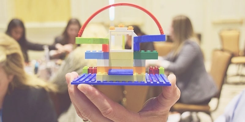 A hand holding a structure made out of LEGO®.